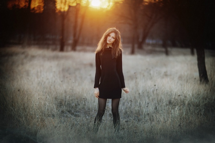 Ksenia Malinina in a black dress in a field