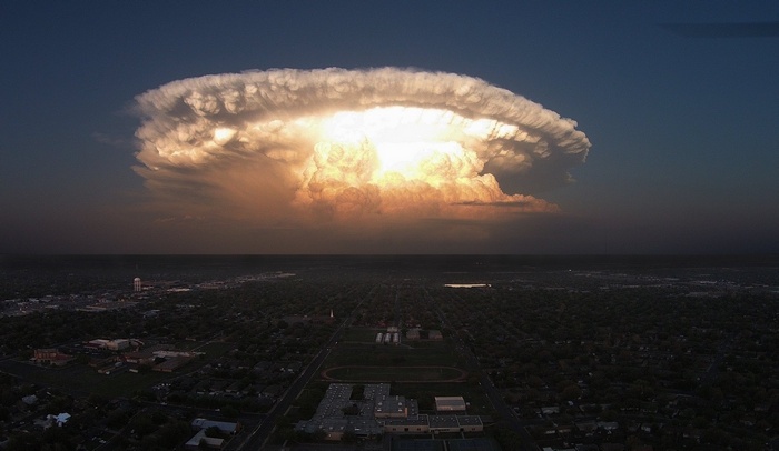 Massive storm cloud over a Texas cityscape at dusk