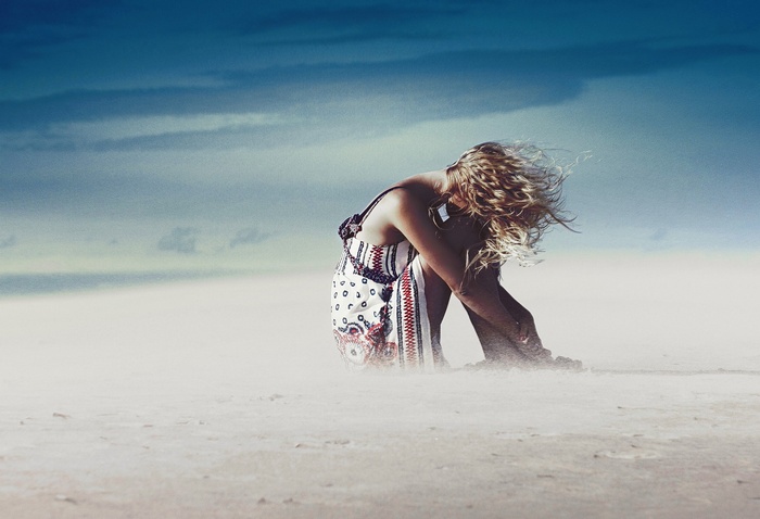 Woman in a dress in a sandstorm
