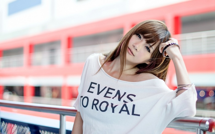 Asian woman with bracelets wearing a white t-shirt