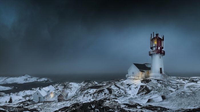 Winter lighthouse and houses in Norway