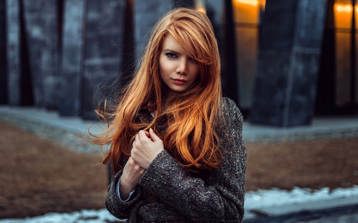 Antonina Bragina with long red hair wearing a coat
