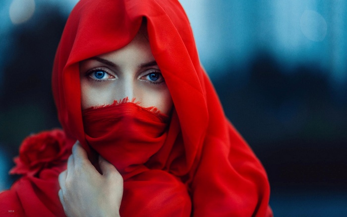 Woman with blue eyes wearing a red scarf