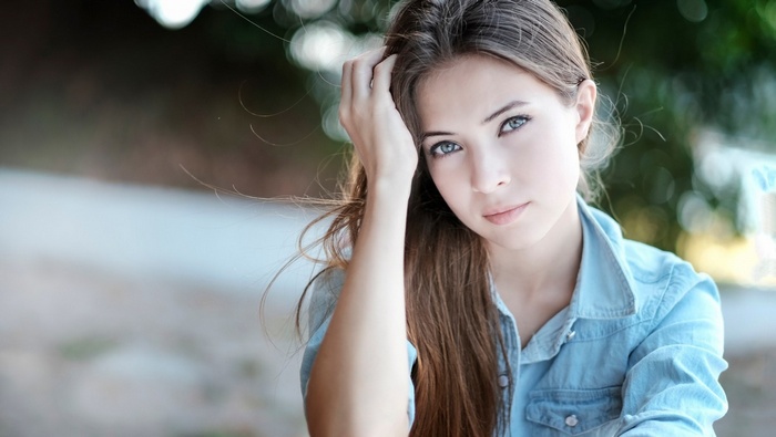 Young woman with long brown hair and blue eyes