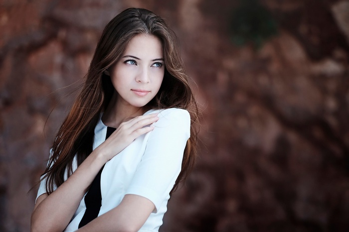 Aigel with long brown hair and blue eyes