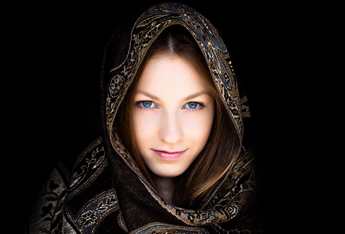 Woman with blue eyes wearing a patterned scarf