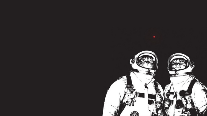 Two cats in astronaut suits looking at a red dot