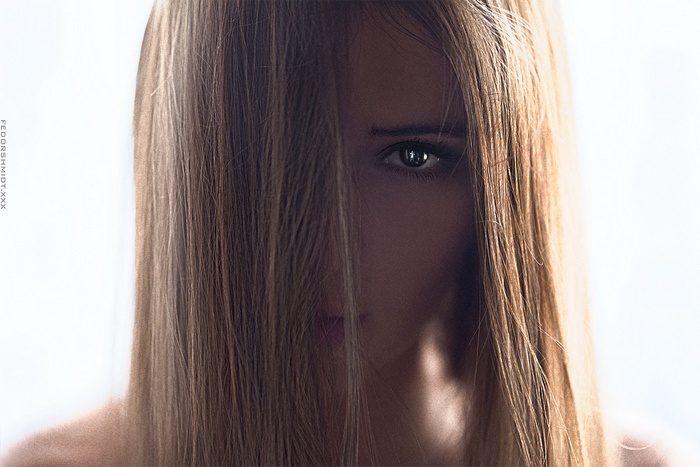 Portrait of a woman with hair covering her face by Fedor Shmidt