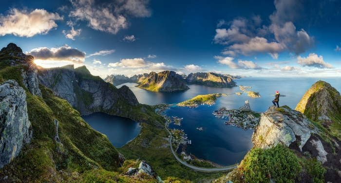 Panorama of Lofoten Islands, Norway with a person on a cliff