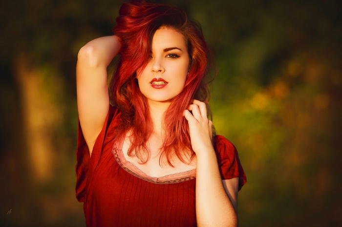 Redhead woman with red lipstick and red dress