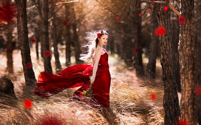Woman in a red dress in a forest