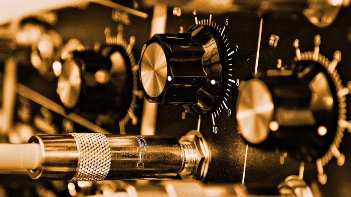 Close-up of audio amplifier knobs and jack