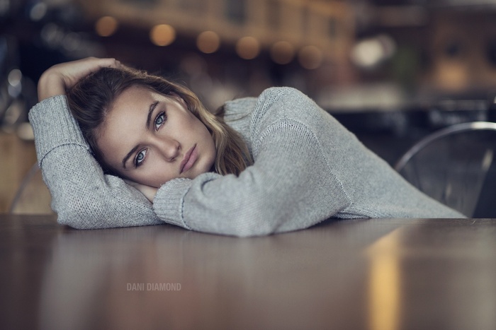Model Dani Diamond with blue eyes wearing a grey sweater