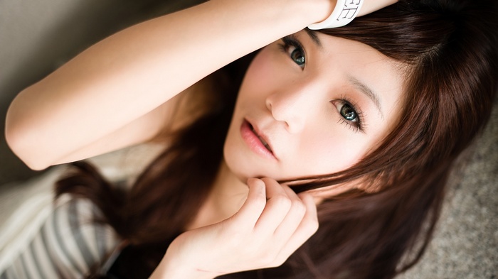 Asian woman with hand on head