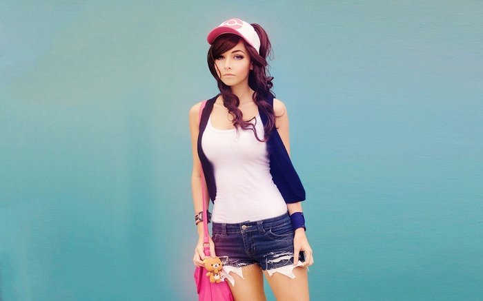 Hilda from Pokemon standing against a blue background