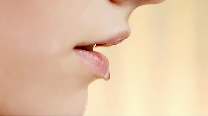 Close-up of lips with a water drop