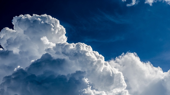 Dramatic clouds against a deep blue sky