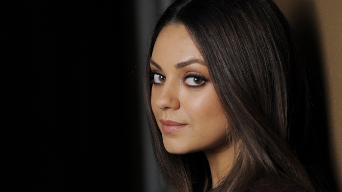 Mila Kunis looking over her shoulder