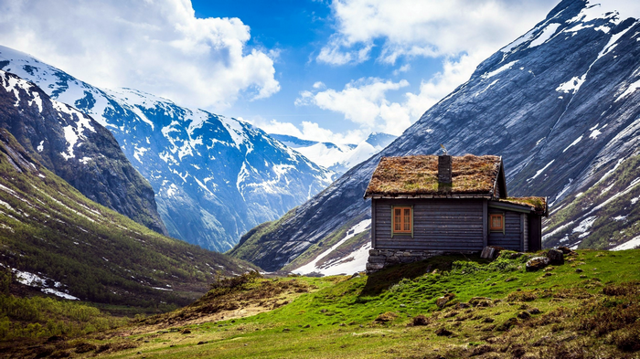 Wooden house with grass roof in Norwegian mountains