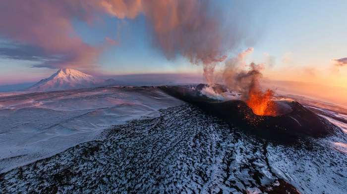 Volcano erupting in Iceland during sunset