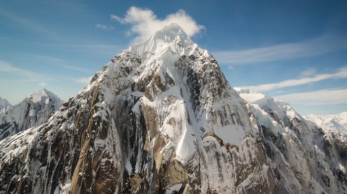 Snow-covered mountains under a blue sky
