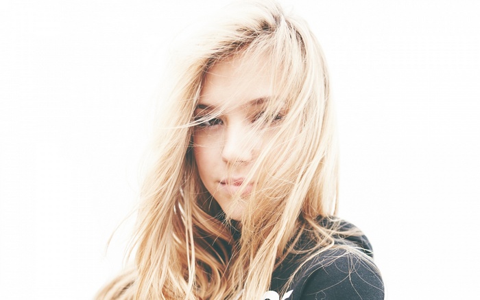 Alexis Ren with blonde hair in her face