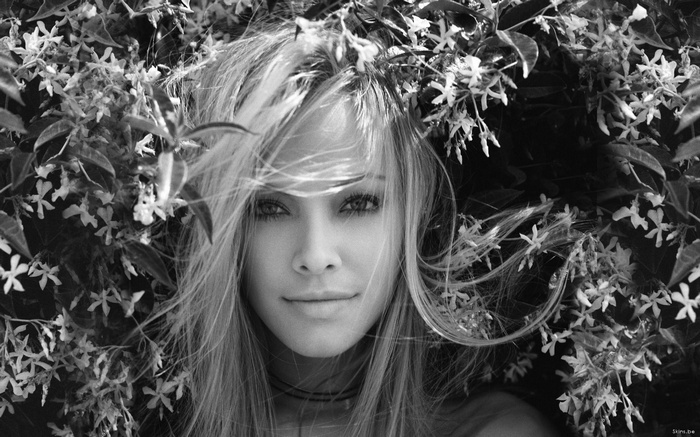 Monochrome portrait of Kristanna Loken among flowers