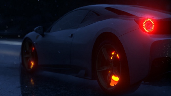 Ferrari sports car with glowing brakes at night