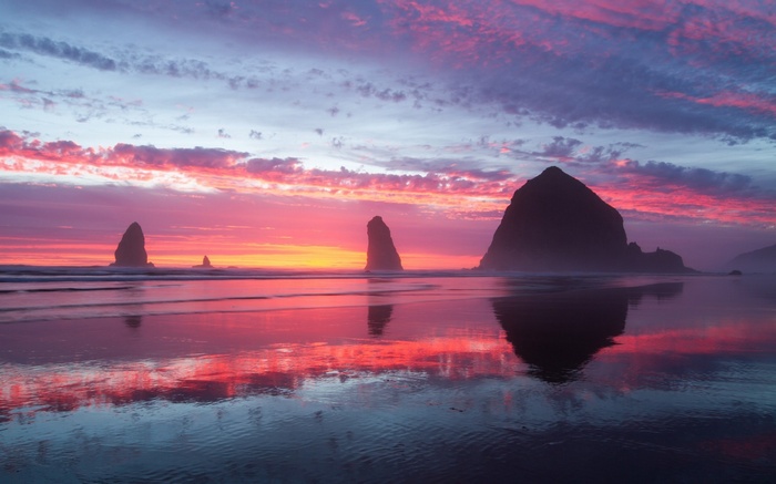 Sunset over the ocean with rock formations