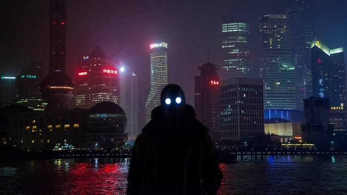 Silhouette with glowing eyes in Shanghai skyline at night