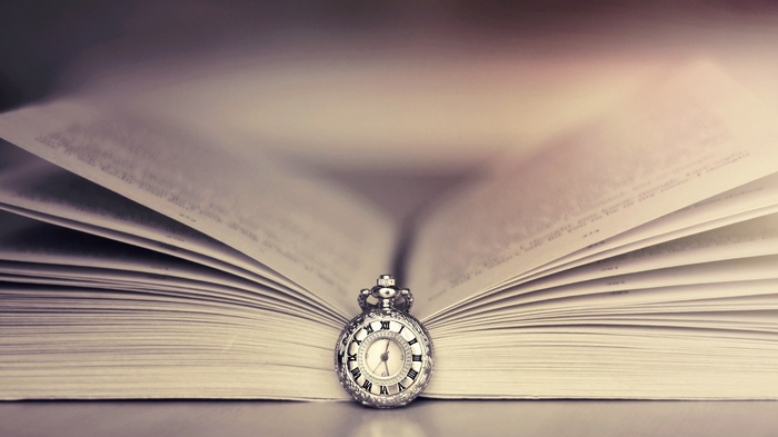 Open book with a pocket watch