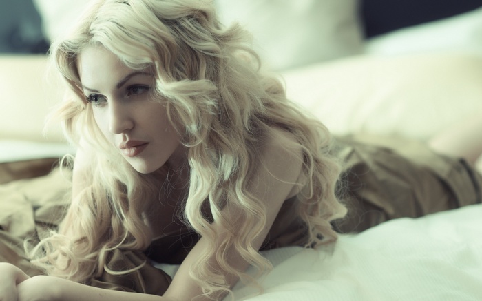 Portrait of a blonde woman lying down