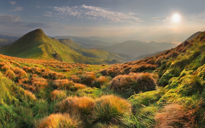 Mountain landscape with sun and clouds