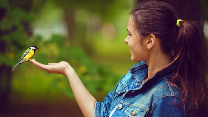 Woman with a bird on her hand