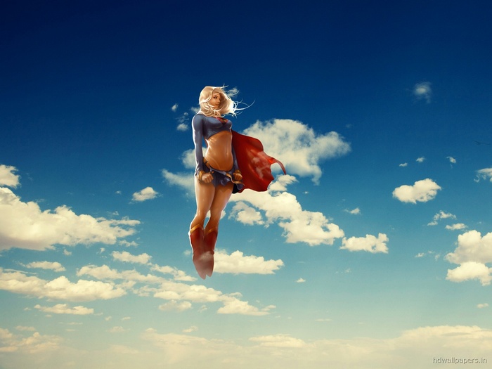 Supergirl flying in the sky with clouds