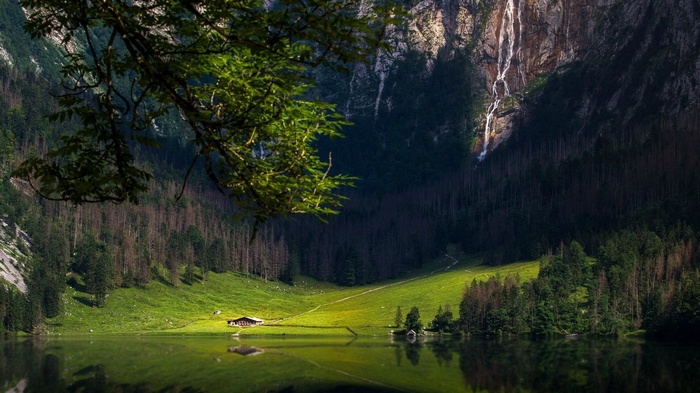 Lake with Waterfall and Cabin in Mountains