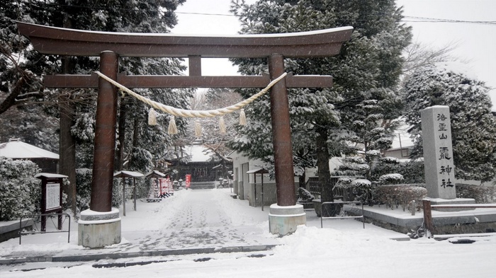 Snowy Japanese Shrine Entrance with Torii Gate