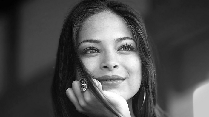 Kristin Kreuk looking up with a smile