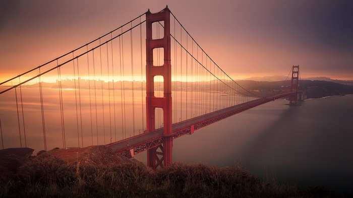 Golden Gate Bridge at sunrise with San Francisco skyline