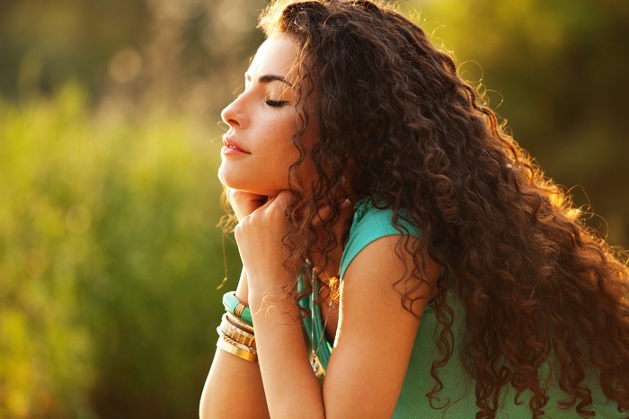 Woman with curly hair outdoors