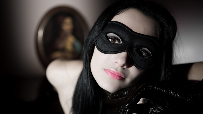 Woman in black Venetian mask and gloves