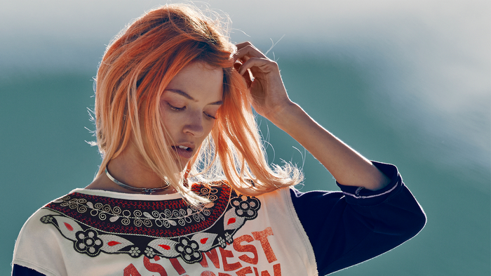 Martha Hunt with orange hair and a patterned shirt