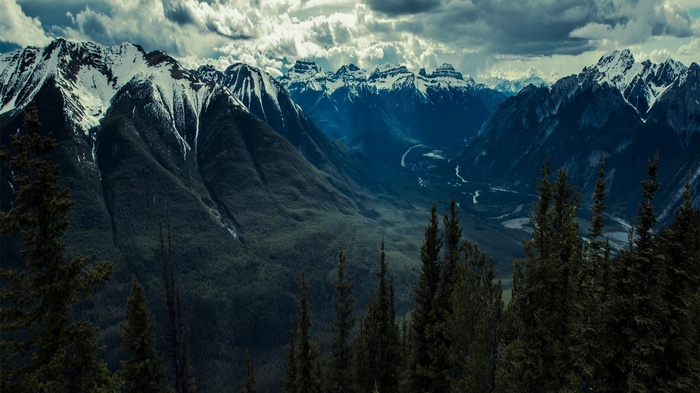 Snow-capped mountains and a valley with a river