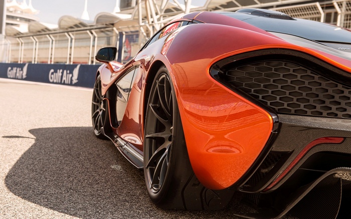 Orange McLaren P1 sports car on a race track
