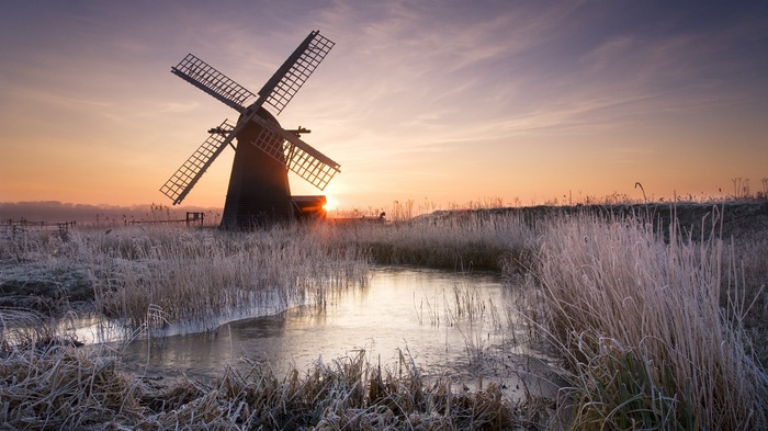 Windmill at sunset in a frosty landscape