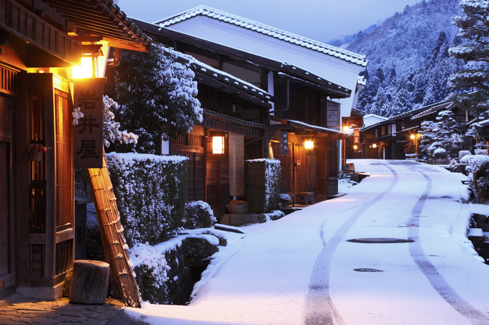Snowy street in a Japanese village at dusk