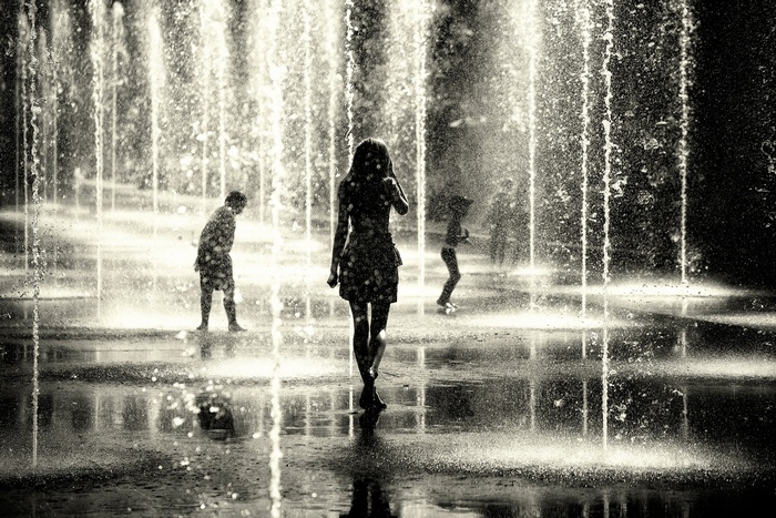People playing in a water fountain