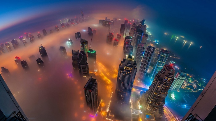 Dubai skyscrapers shrouded in mist at night