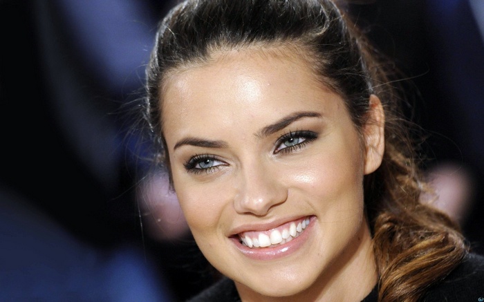 Adriana Lima smiling with blue eyes