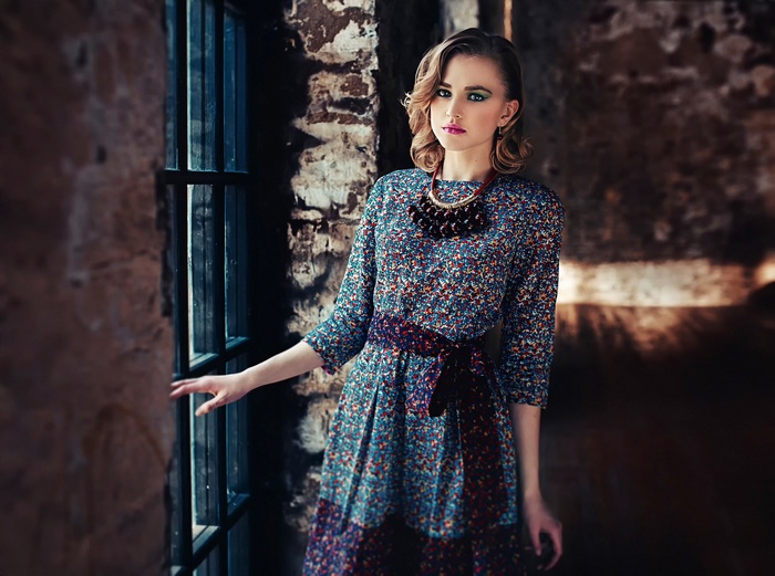 Alla Emelyanova in a floral dress by the window